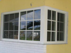 A window with a reflection of the sky in it.